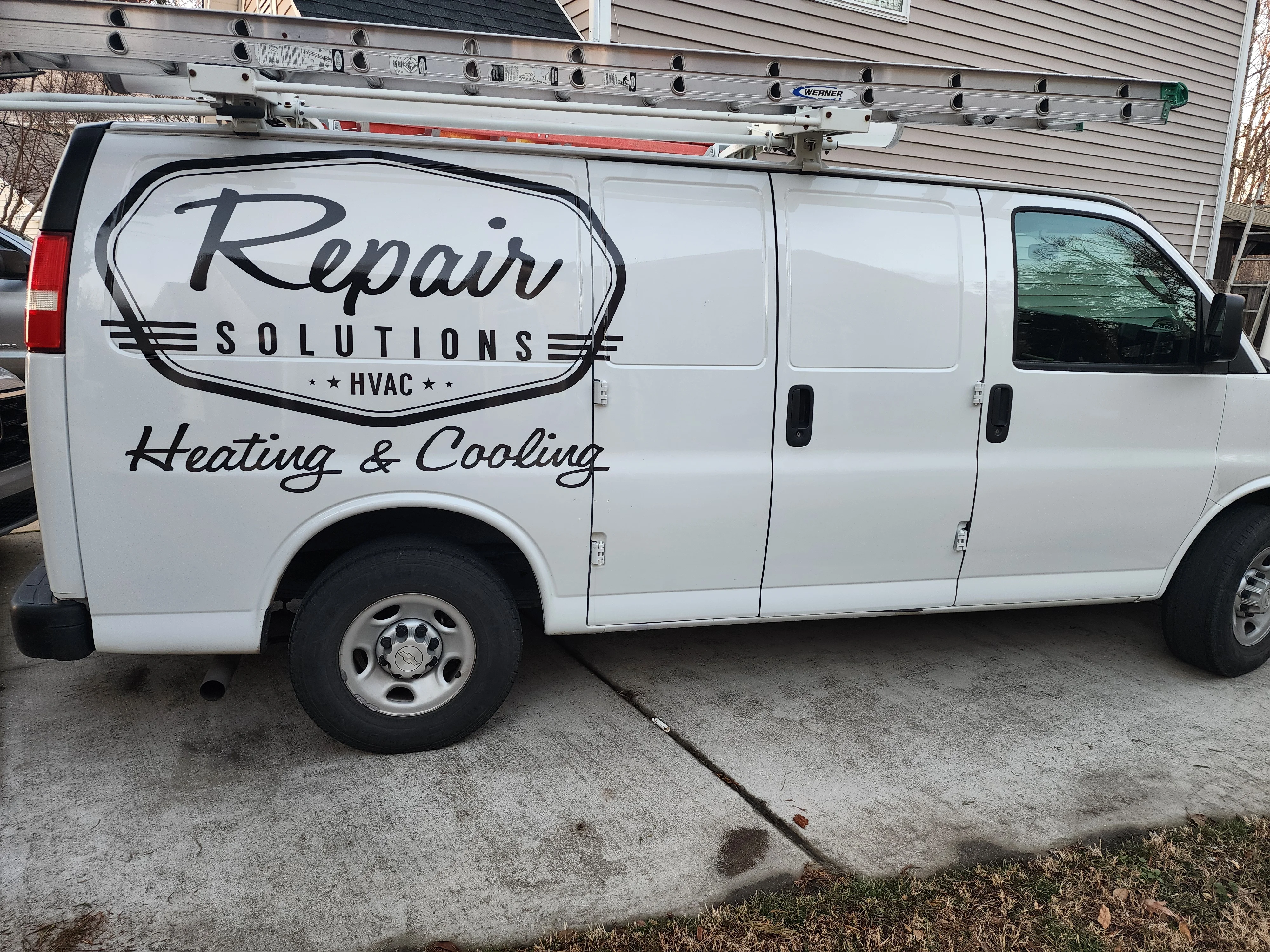 White service van with custom vinyl wrap displaying HVAC company branding and heating cooling services